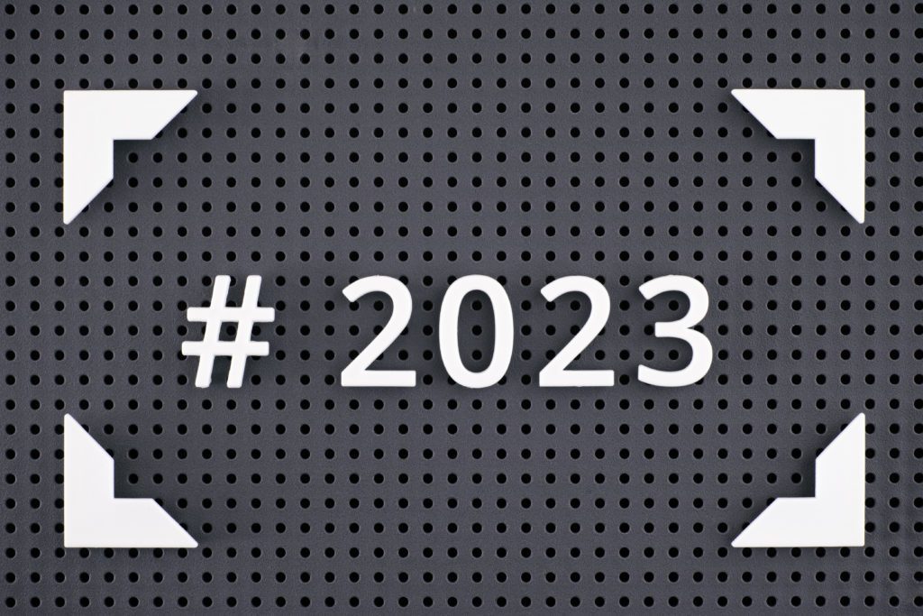 The Hashtag 2023 spelled out with white numbers in a frame on a gray pegboard