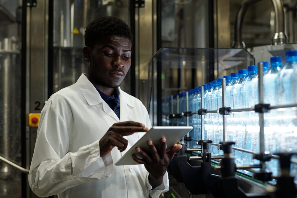 Laboratory worker uses online tools on a tablet. 